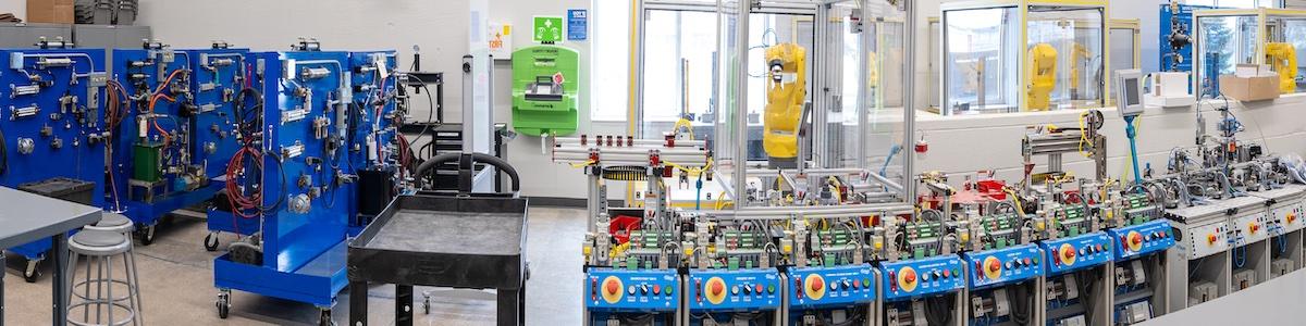 Industrial robots and assembly line in a workshop next to tool storage racks