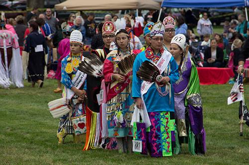 Candtidates for Powwow princess stand in a line on the Fairgrounds